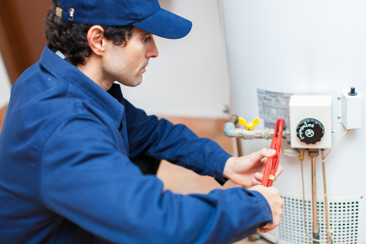 Technician servicing residential heating equipment