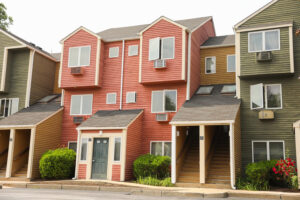Multi-level multi-family home in Woods Cross with air conditioning units, showcasing residential HVAC solutions for summer heat.